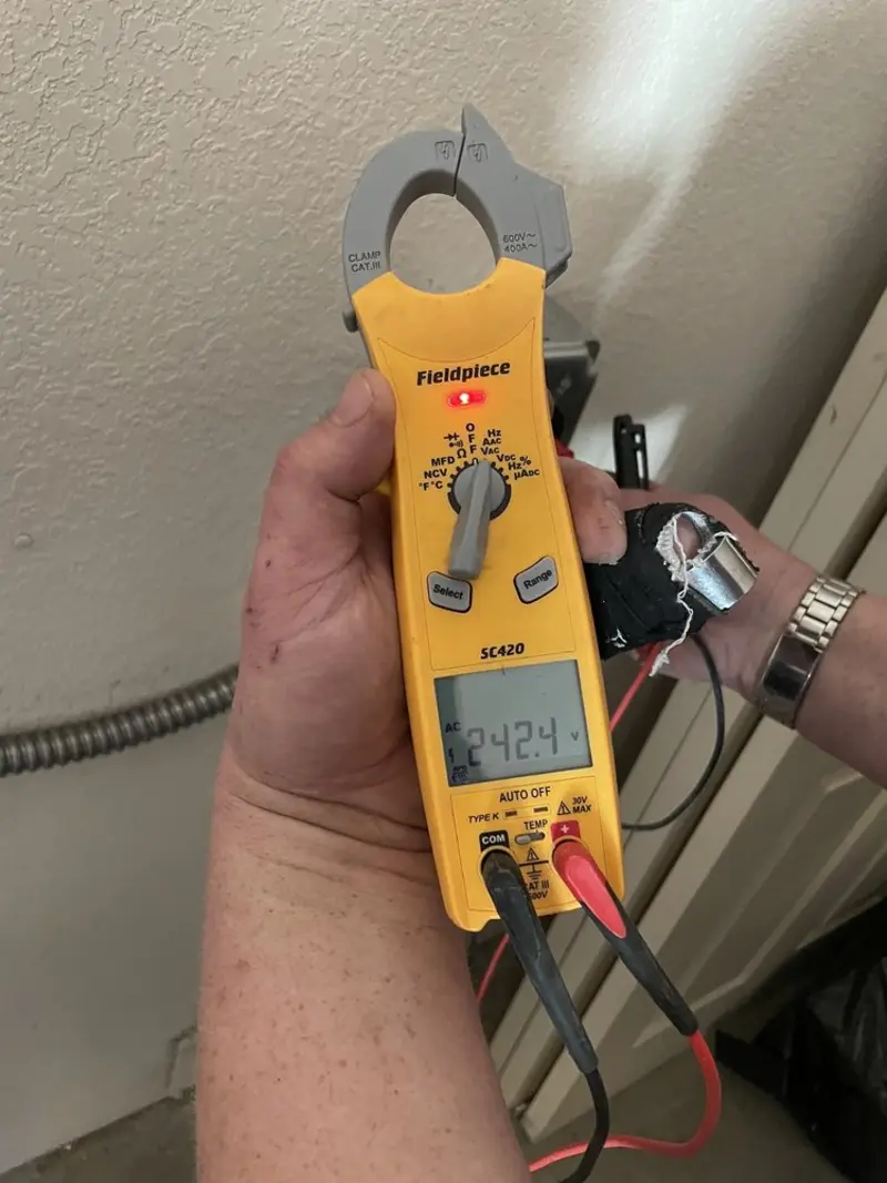 Voltage testing with clamp meter during Ceiling Fan Installation in Cheval
